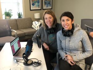 Kristin Revere and Alyssa Veneklase sitting together in an office recording a podcast together