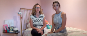 Alyssa of Gold Coast Doulas sits with a woman on a bed in a child's room