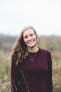 Alexandrea of Gold Coast Doulas stands in a field