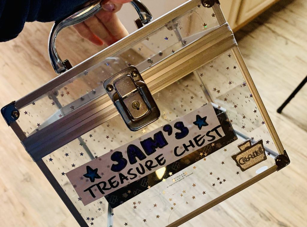 Sam's Treasure Chest Sticker on the front of a latched clear box