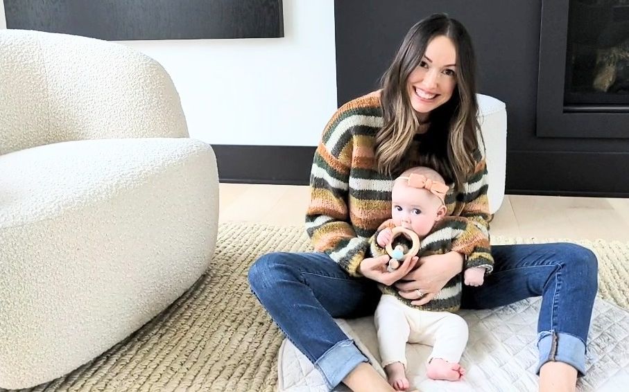 Heidi McDowell poses with her infant on the floor