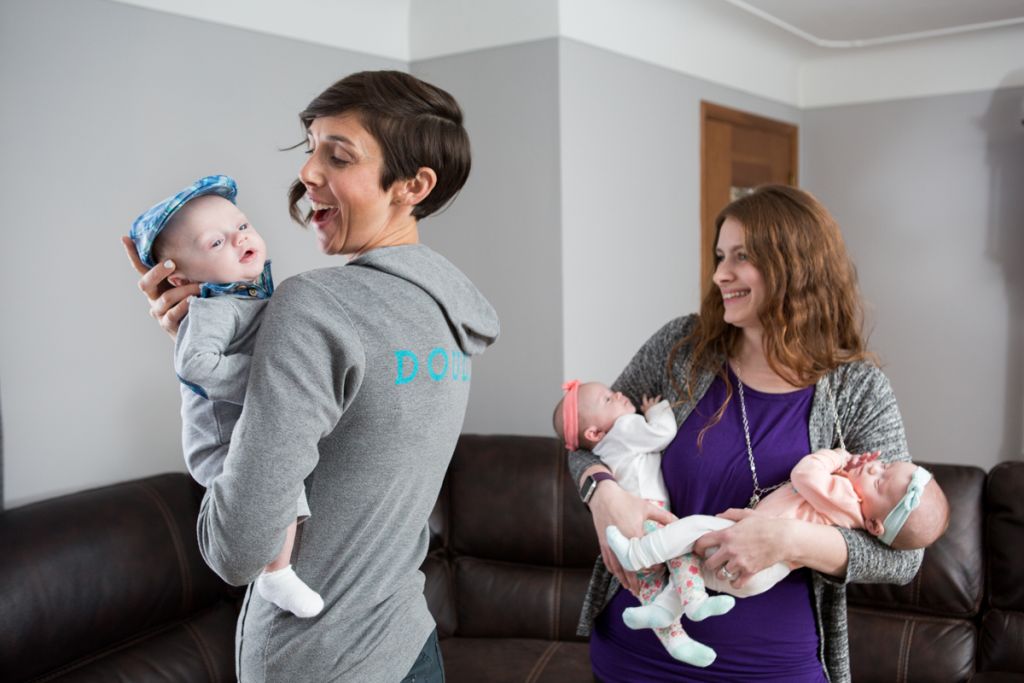 Alyssa Veneklase, Postpartum Doulas of Gold Coast Doulas, assists a mom of triplets