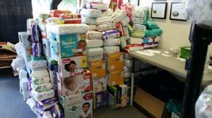 Stacks of diapers in boxes and wipes in an office
