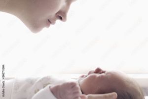 Mother admiring a sleeping infant