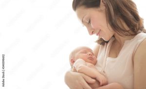 Mother admiring and holding her sleeping infant