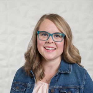 Ashley Forton of Gold Coast Doulas wearing blue framed classes and a jean jacket