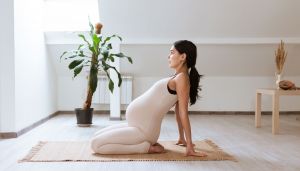 Pregnant woman posing on a yoga mat
