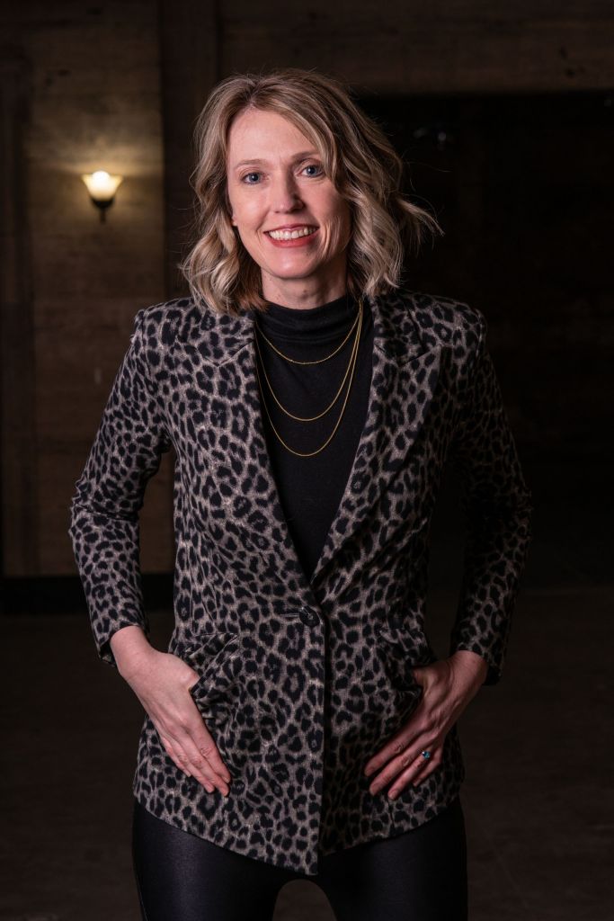 Kristin Revere poses wearing a leopard print blazer