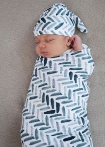 Swaddled sleeping infant with hat