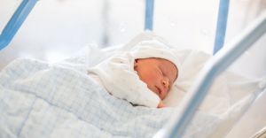 Sleeping newborn in a hospital basinet