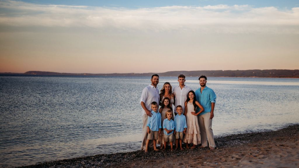 Jene'e of Gold Coast Doulas poses with her family on a beach