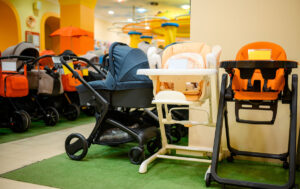 Rows of strollers and highchairs in a store setting