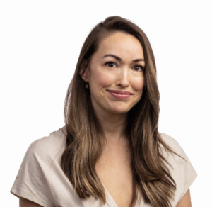 Heidi from Mind Body Baby smiling wearing a beige v-neck against a white background