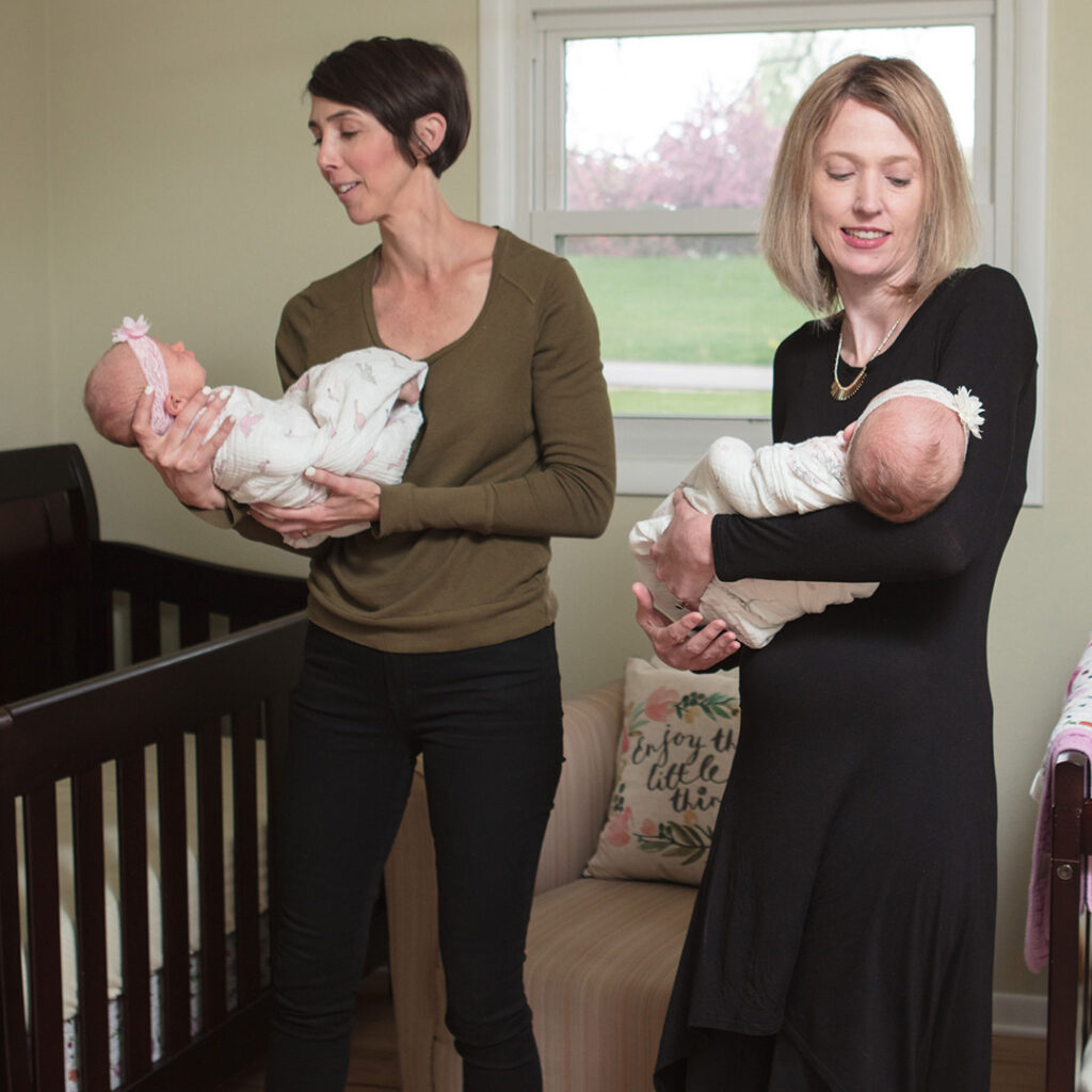 Alyssa and Kristin from Gold Coast Doulas holding babies in a nursery