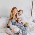 Jessica Hull, founder of Mother Me, sits with her three children.