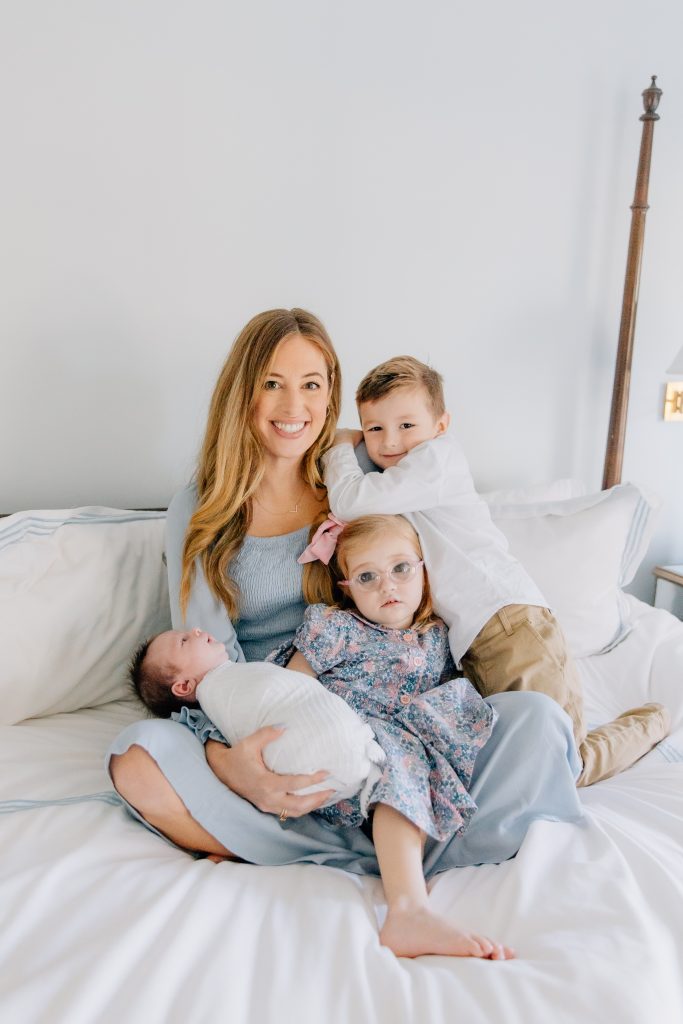 Jessica Hull, founder of Mother Me, sits with her three children.