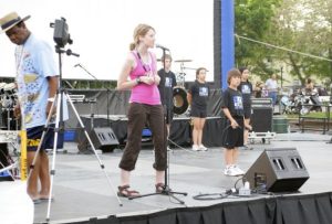 Kristin Revere Speaking on outdoor stage