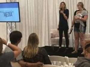 Kristin Revere speaking on stage inside