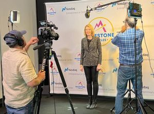 Woman being recording by a camera with a microphone over her head