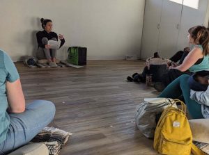 Three people sitting down and talking